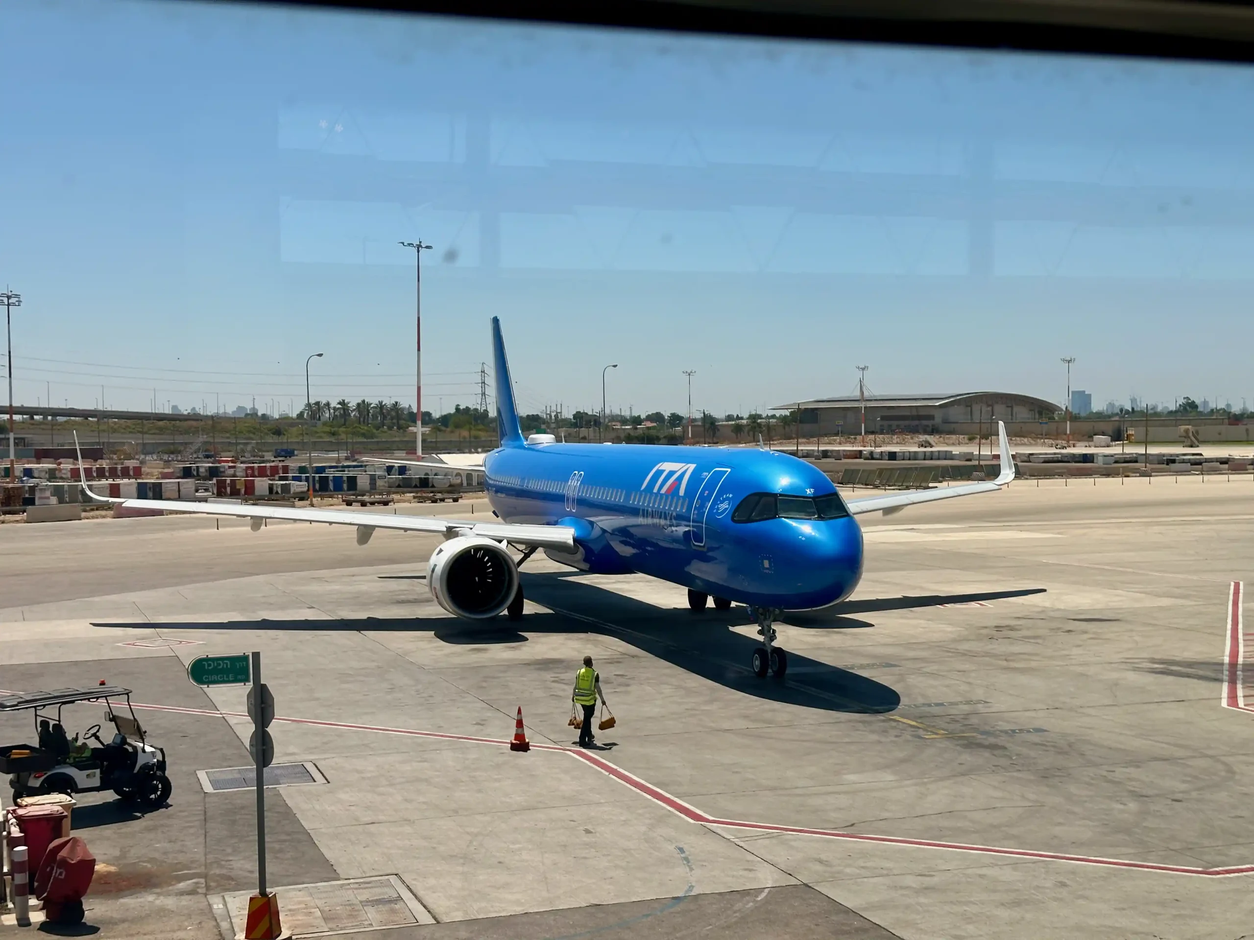 a blue airplane on the tarmac