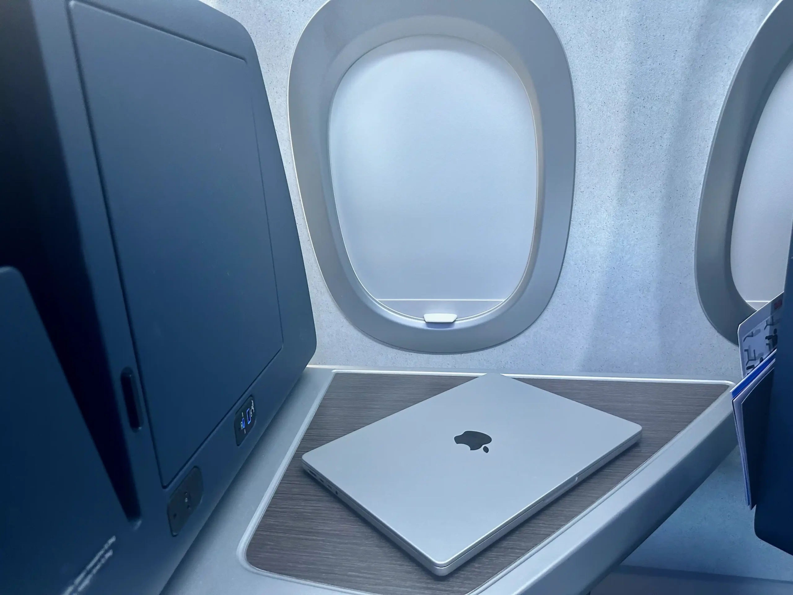 a laptop on a table in an airplane