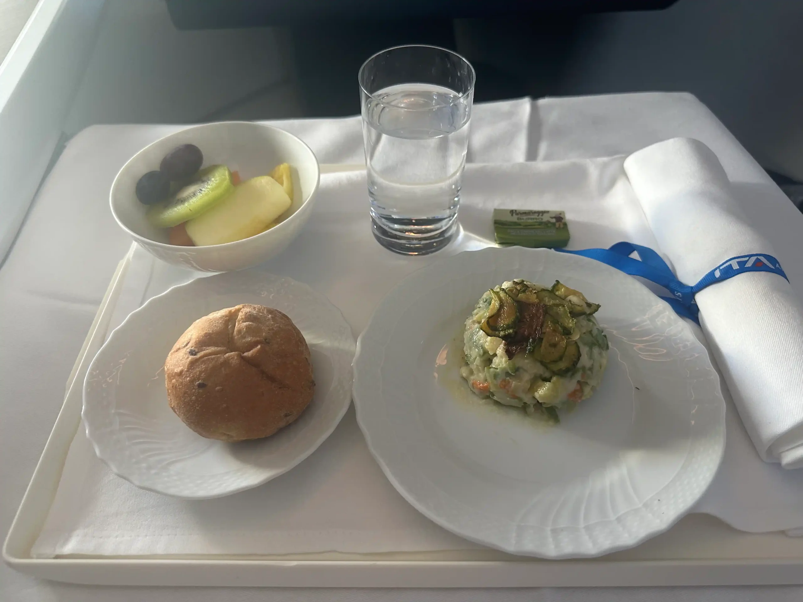 a tray with food and a glass of water