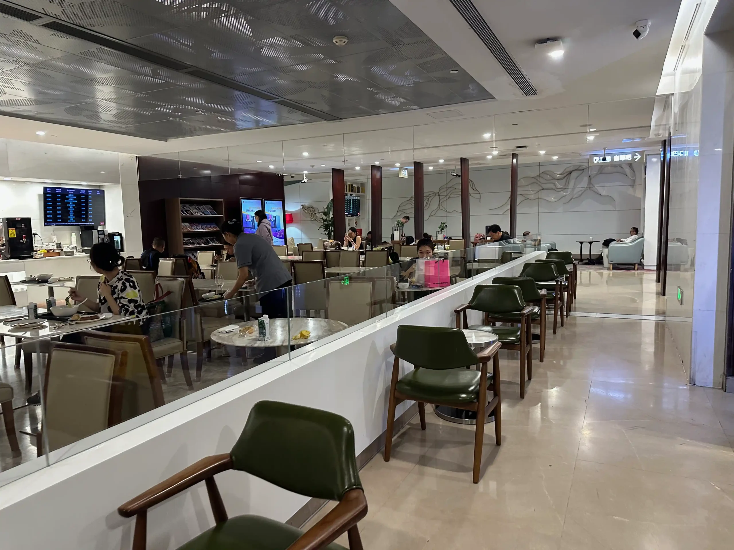 a group of people sitting at a counter in a restaurant