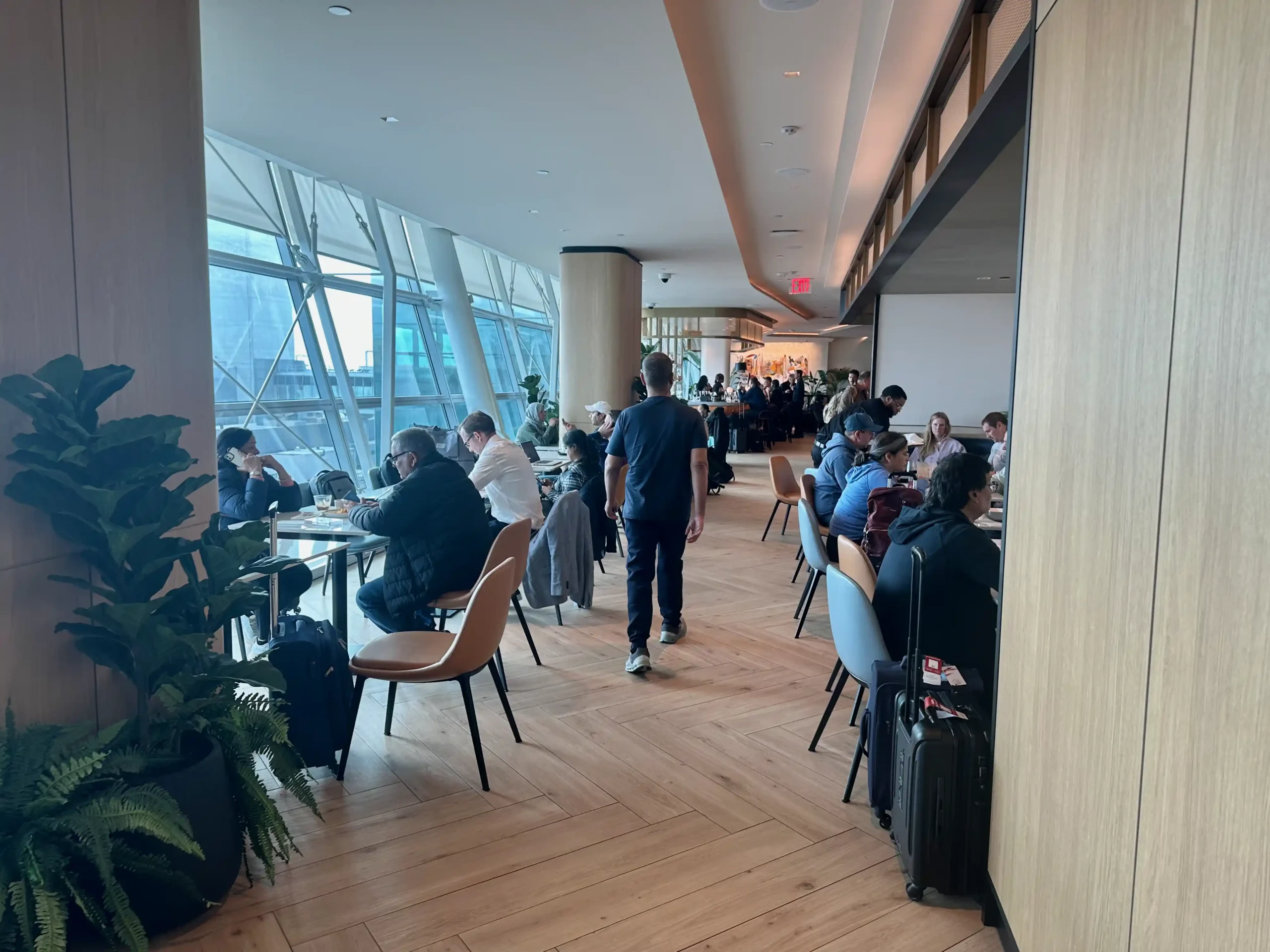 a group of people in a room with large windows