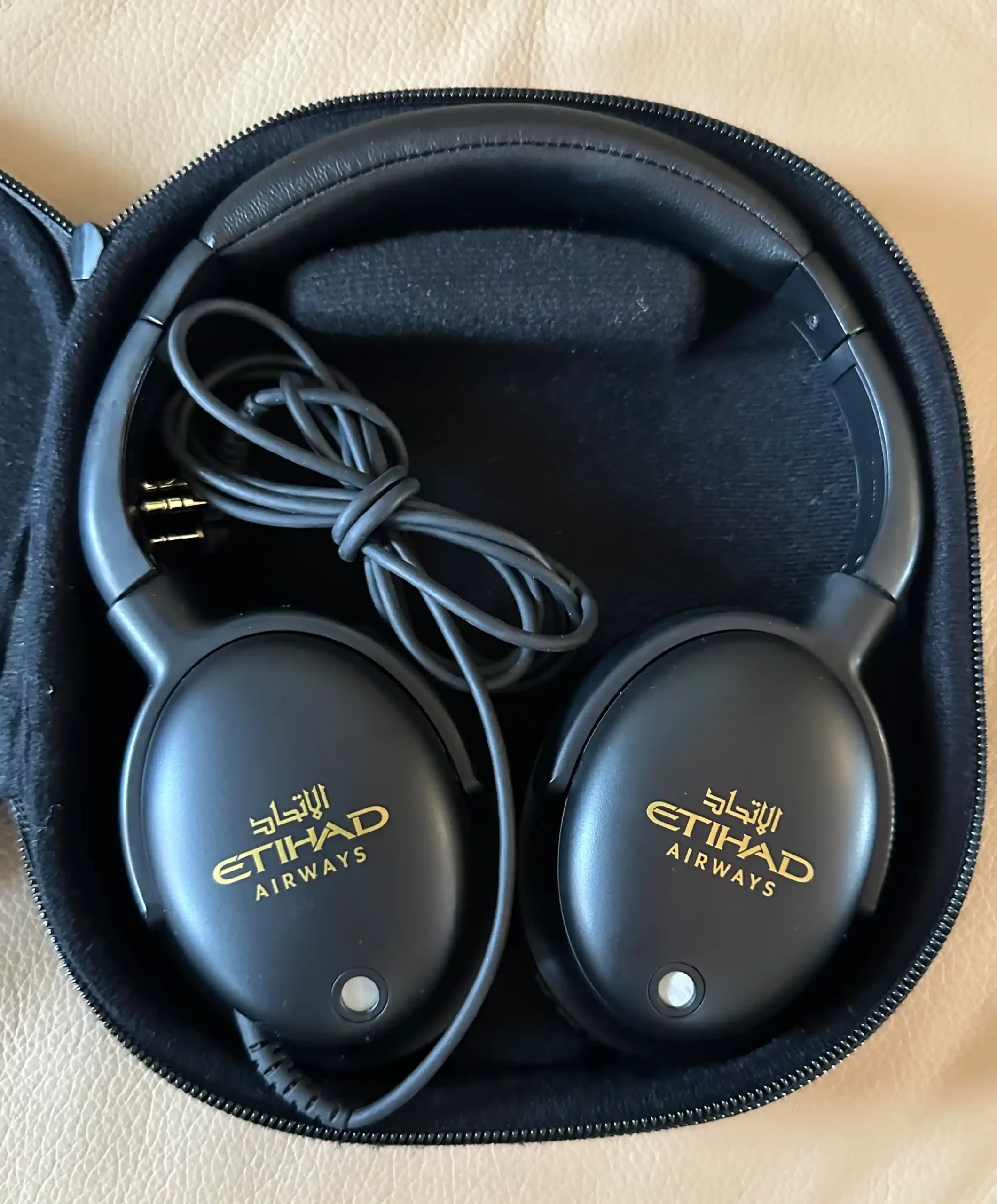 a pair of black headphones in a black case