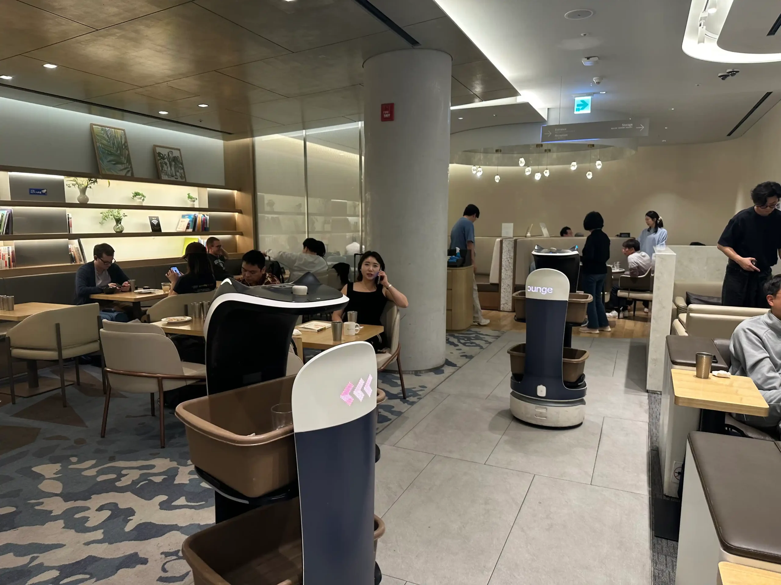 a group of people sitting at tables in a restaurant