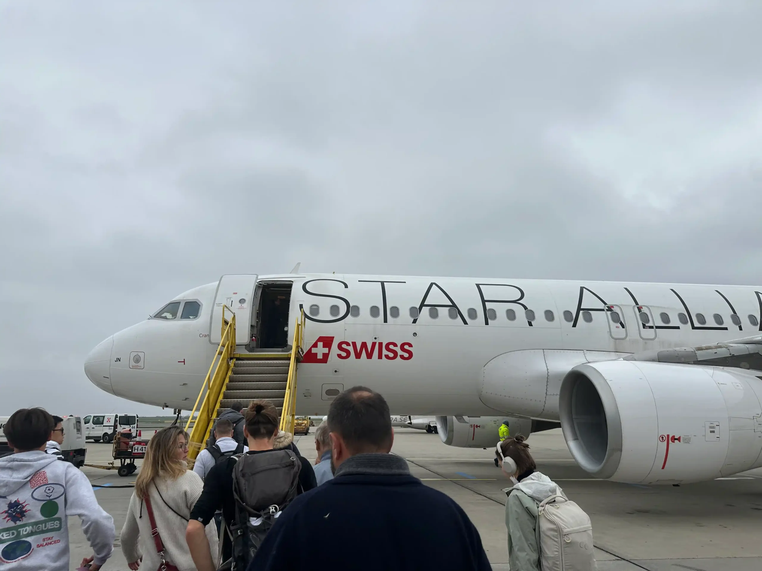 a group of people walking by an airplane