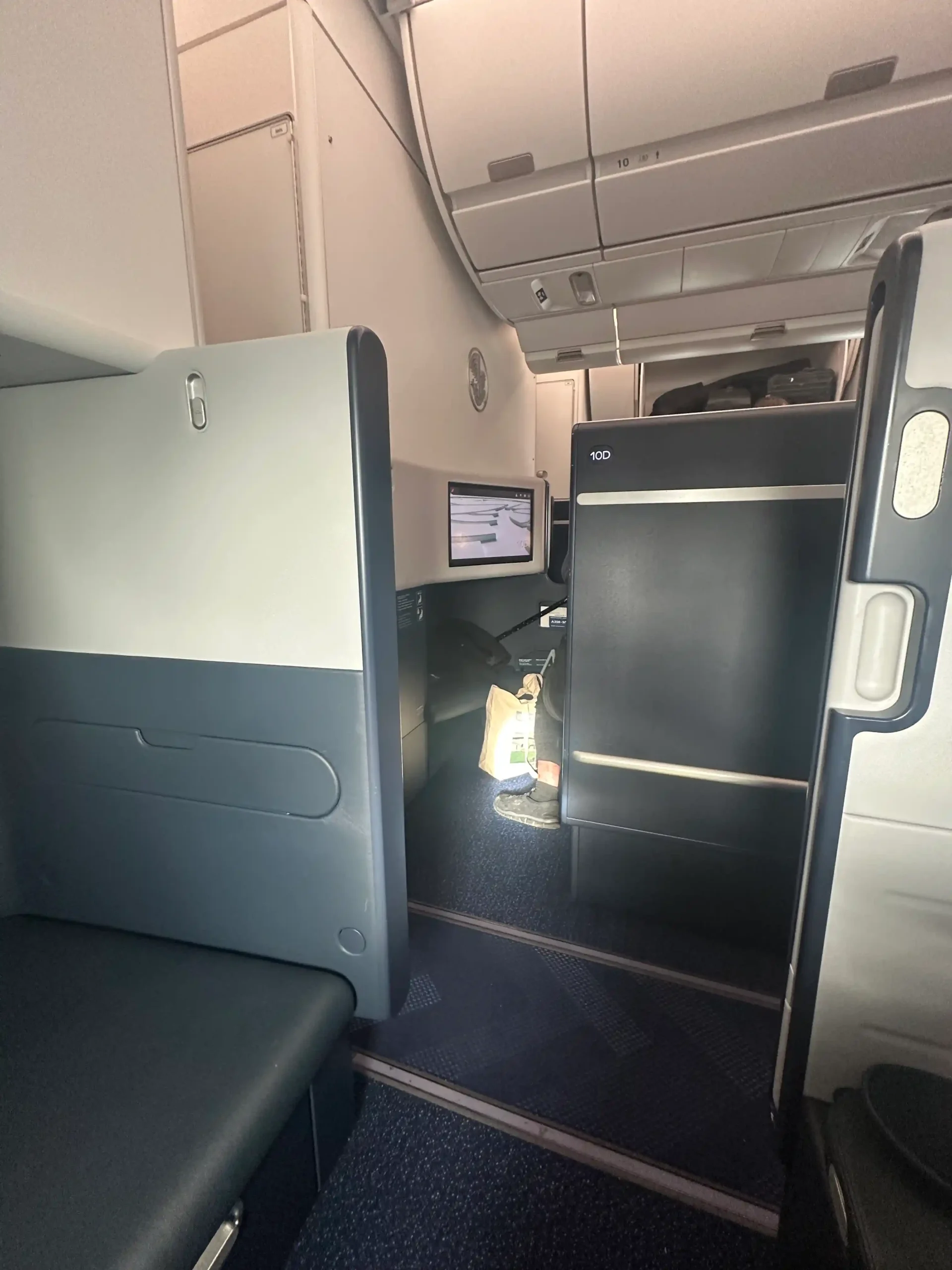 a seat and a desk in an airplane